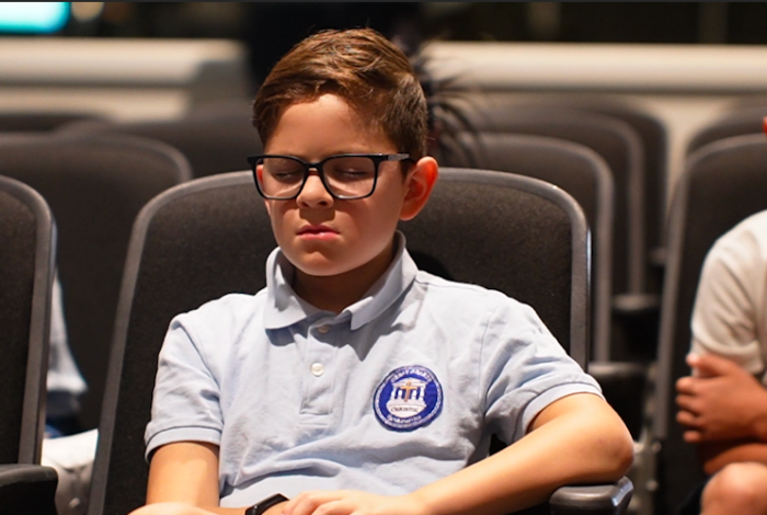 Young boy praying at Chapel